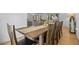 Dining area with a wooden table and seating next to the kitchen and living area at 2117 S Balsam Ct, Lakewood, CO 80227