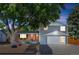 Charming front exterior of home featuring a two-car garage, landscaped front yard, and stylish front door at 2117 S Balsam Ct, Lakewood, CO 80227