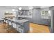 Well-appointed kitchen with stainless steel appliances, an island with bar seating, and stylish gray cabinets at 2117 S Balsam Ct, Lakewood, CO 80227
