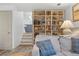 Comfortable living room featuring a built-in bookcase and easy access to kitchen area at 2117 S Balsam Ct, Lakewood, CO 80227