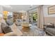 Comfortable living room featuring a built-in bookcase and sliding glass doors to a patio at 2117 S Balsam Ct, Lakewood, CO 80227