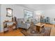 Cozy living area features hardwood floors, comfortable seating, and natural light from a nearby window at 2117 S Balsam Ct, Lakewood, CO 80227