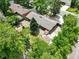 Aerial view of the brick home with mature trees and a storage shed at 3784 Swadley St, Wheat Ridge, CO 80033