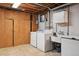 Basement laundry area includes a washer, dryer, utility sink, and ample storage at 3784 Swadley St, Wheat Ridge, CO 80033