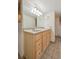 Bathroom featuring a double sink vanity and large mirror at 3784 Swadley St, Wheat Ridge, CO 80033