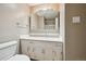 Bright bathroom featuring a large mirror, vanity with sink, and essential fixtures at 3784 Swadley St, Wheat Ridge, CO 80033