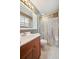 Standard bathroom featuring a vanity with sink and shower with glass doors at 3784 Swadley St, Wheat Ridge, CO 80033