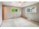 Bedroom featuring carpet, two windows, and a ceiling fan with light at 3784 Swadley St, Wheat Ridge, CO 80033