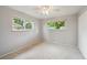 Bedroom featuring carpet, two windows, and a ceiling fan with light at 3784 Swadley St, Wheat Ridge, CO 80033