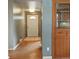 Warm and inviting entryway featuring hardwood floors, a built-in cabinet, and convenient access to the front door at 3784 Swadley St, Wheat Ridge, CO 80033