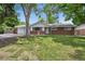Charming brick ranch-style home with a well-maintained lawn and mature trees providing ample shade at 3784 Swadley St, Wheat Ridge, CO 80033