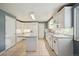 Bright kitchen with white cabinets, tile flooring, and stainless steel appliances, offering a clean and modern space at 3784 Swadley St, Wheat Ridge, CO 80033