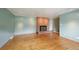 Spacious living room with hardwood floors, a brick fireplace, and light-colored walls at 3784 Swadley St, Wheat Ridge, CO 80033
