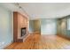 Bright living room boasts a charming fireplace, hardwood floors, and ample natural light at 3784 Swadley St, Wheat Ridge, CO 80033