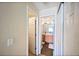Hallway view leading to a full bathroom with a sink, cabinet, and mirror at 12711 Colorado Blvd # 914, Thornton, CO 80241