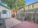 Private backyard with a patio, wooden deck and a charming garden area with fence at 1612 N High St, Denver, CO 80218