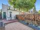 A private backyard features a brick patio, wooden deck, and mature landscaping at 1612 N High St, Denver, CO 80218