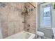 Bathtub and shower area with stylish tile accents and a decorative touch at 1612 N High St, Denver, CO 80218