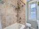 Bathroom showcases a tile shower, tub, and decorative hanging plants for a soothing atmosphere at 1612 N High St, Denver, CO 80218