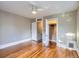 Spacious bedroom with hardwood floors, ceiling fan, and a walk-in closet with an open door at 1612 N High St, Denver, CO 80218