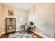 Bright bedroom featuring a modern desk setup, neutral walls, and a geometric rug at 1612 N High St, Denver, CO 80218