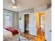 Inviting bedroom with hardwood floors, closet and view to a hallway at 1612 N High St, Denver, CO 80218