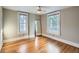 Spacious bedroom with hardwood floors, large windows, and ample natural light, creating a bright and comfortable atmosphere at 1612 N High St, Denver, CO 80218