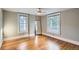 Bright bedroom featuring hardwood floors, fresh paint, and natural light from two windows at 1612 N High St, Denver, CO 80218