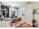 Modern kitchen with stainless steel appliances, quartz countertops, a breakfast bar, and ample cabinet space at 1612 N High St, Denver, CO 80218