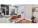 Modern kitchen featuring a breakfast bar with seating, stainless steel appliances, and white cabinetry at 1612 N High St, Denver, CO 80218