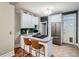 Updated kitchen with stainless appliances, breakfast bar, and white cabinetry, offering a stylish and functional cooking space at 1612 N High St, Denver, CO 80218
