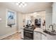 Bright kitchen with stainless steel appliances connected to the living room and dining areas at 1612 N High St, Denver, CO 80218