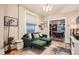 Bright living room features an elegant green sofa with comfortable seating and a dining area nearby at 1612 N High St, Denver, CO 80218