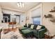 Bright living room features an elegant green sofa with comfortable seating, connected to the kitchen at 1612 N High St, Denver, CO 80218