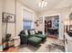 Comfortable living room with a green sofa and view into dining room at 1612 N High St, Denver, CO 80218