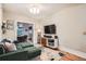 Cozy living room showcasing an elegant sofa, entertainment center, and beautiful hardwood floors at 1612 N High St, Denver, CO 80218