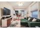 Stylish living room showcasing a sleek TV setup, hardwood floors and an elegant green sofa at 1612 N High St, Denver, CO 80218