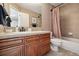 Traditional-style bathroom featuring a vanity with a bathtub and shower at 17490 W 67Th Ave, Arvada, CO 80007