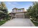 Charming home with a three-car garage, manicured lawn, and beautiful curb appeal at 17490 W 67Th Ave, Arvada, CO 80007