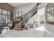 Grand foyer with staircase, elegant tile flooring, and plenty of natural light at 17490 W 67Th Ave, Arvada, CO 80007