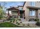 Inviting front porch with stone accents, dark wood, and manicured landscaping at 17490 W 67Th Ave, Arvada, CO 80007
