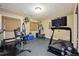 Home gym featuring a treadmill, weight machines, rubber flooring, and natural light at 17490 W 67Th Ave, Arvada, CO 80007