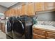 Laundry room features modern washer/dryer set, ample cabinets, and a utility sink at 17490 W 67Th Ave, Arvada, CO 80007