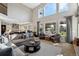 Spacious living room featuring high ceilings, large windows, and stylish decor at 17490 W 67Th Ave, Arvada, CO 80007
