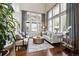 Bright living room with large windows and comfortable seating arrangement at 17490 W 67Th Ave, Arvada, CO 80007