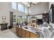 Bright living room with large windows, high ceilings, and a cozy fireplace at 17490 W 67Th Ave, Arvada, CO 80007
