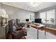 Comfortable home office with wood desk, two leather chairs, and modern computer equipment at 17490 W 67Th Ave, Arvada, CO 80007