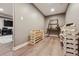 Bright wine cellar with racks of wine storage and vinyl flooring in the basement at 17490 W 67Th Ave, Arvada, CO 80007