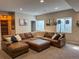 Cozy basement featuring a large sectional sofa and natural light, creating a comfortable living space at 5893 Lasso Pl, Parker, CO 80134