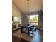 Bright dining area featuring a dark wood table, bench seating, stylish lighting, and a large window at 5893 Lasso Pl, Parker, CO 80134